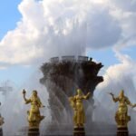Stunning fountain with golden statues under a blue sky at VDNKh, showcasing artistic craftsmanship.