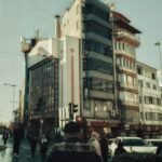 Street scene featuring modern architecture and pedestrians in daylight.